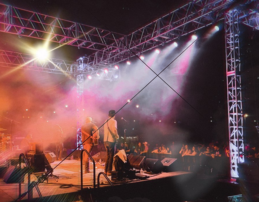 outdoor concert performer on stage with large crowd Relax Park OK