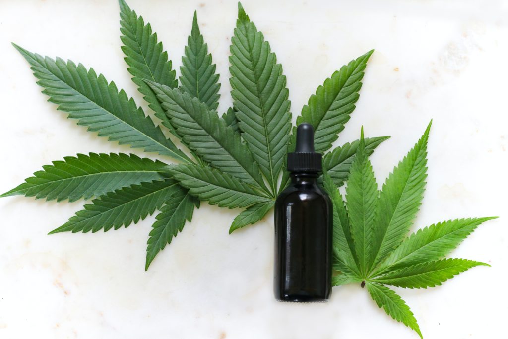 tincture bottle with cannabis leaves