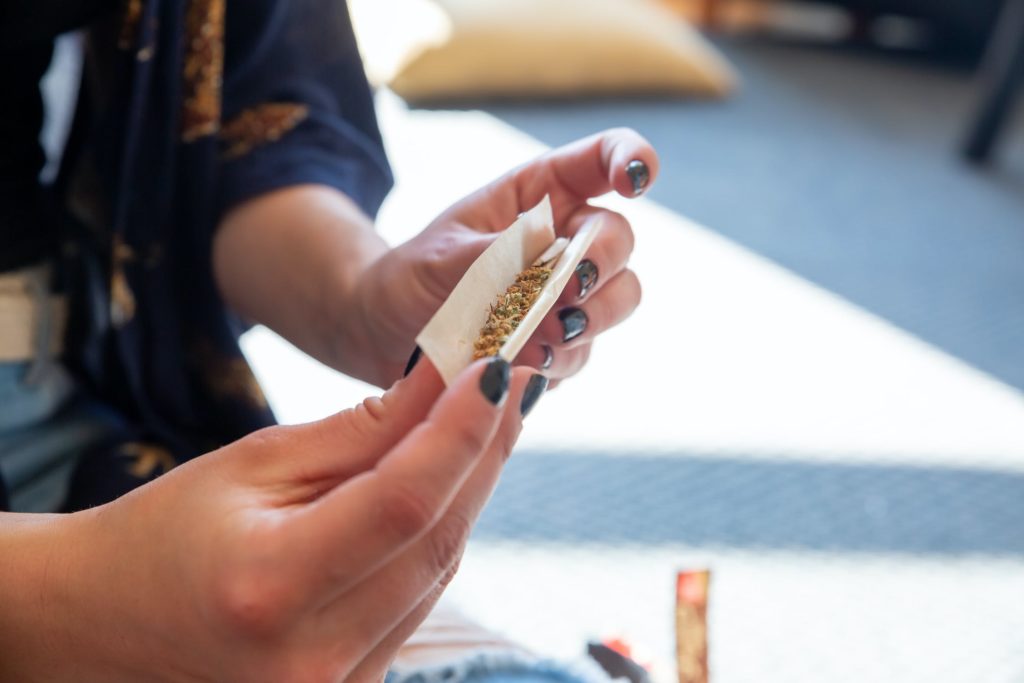 woman rolling joint cannabis in germany